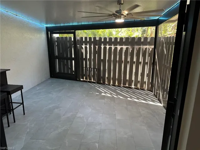 Unfurnished sunroom featuring ceiling fan