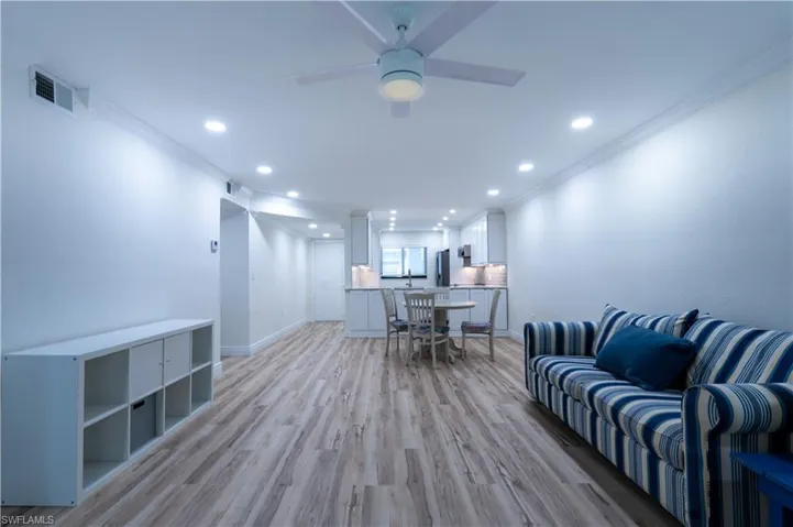 Office space featuring crown molding, ceiling fan, and light wood-type flooring