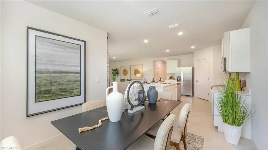 Dining area with recessed lighting and light tile patterned floors