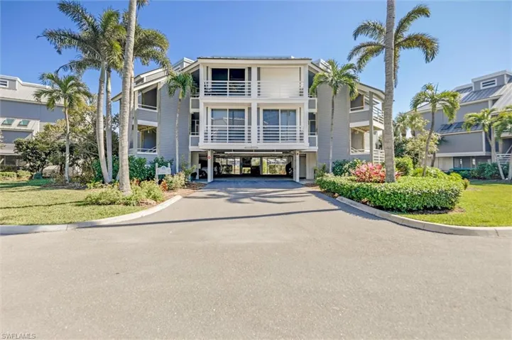 View of property featuring a carport and driveway