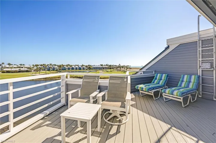 Wooden deck with a water view, golf course view, and a residential view
