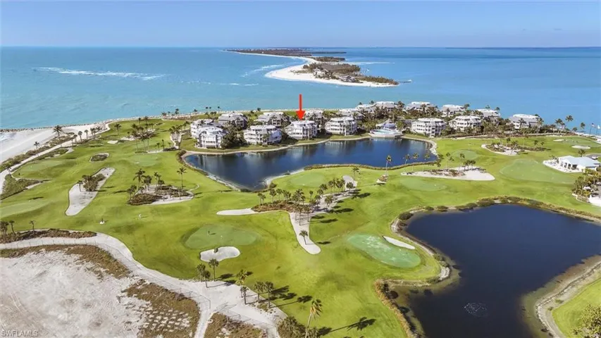 Drone / aerial view of a large body of water and a golf course