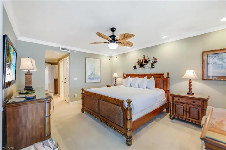 Carpeted bedroom with recessed lighting, crown molding, a ceiling fan, and a closet