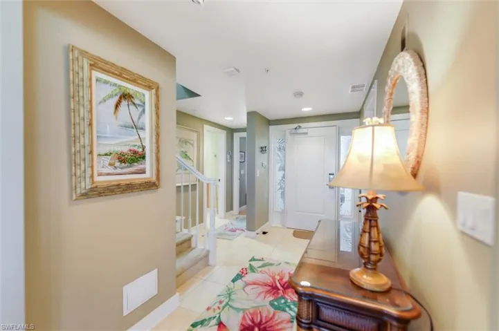Hallway with light tile patterned flooring and recessed lighting