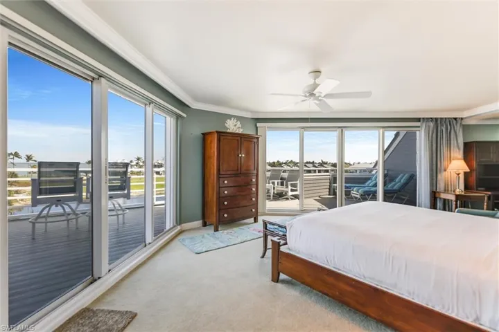 Bedroom with access to outside, crown molding, carpet, and a ceiling fan