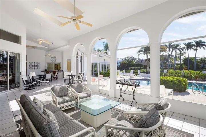 View of patio / terrace featuring outdoor dining area, outdoor lounge area, a ceiling fan, and an outdoor pool