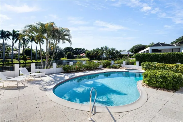 View of pool with a patio, a pool with connected hot tub, and a water view