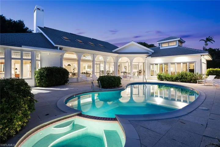 View of swimming pool with a patio, a pool with connected hot tub, and french doors