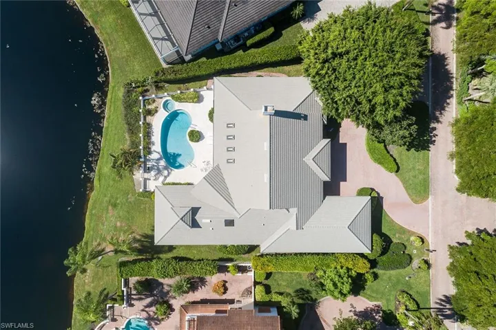 Bird's eye view of a pool and a nearby body of water