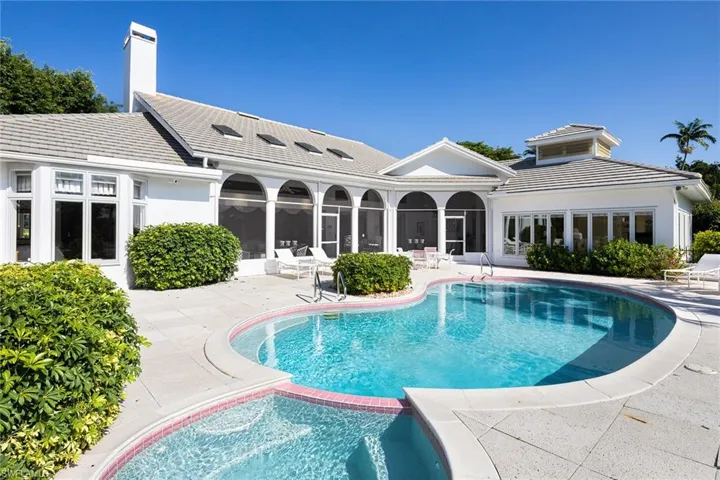 View of pool with a patio, a pool with connected hot tub, and a sunroom