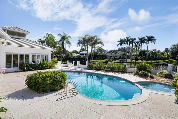 View of pool featuring a patio and a pool with connected hot tub