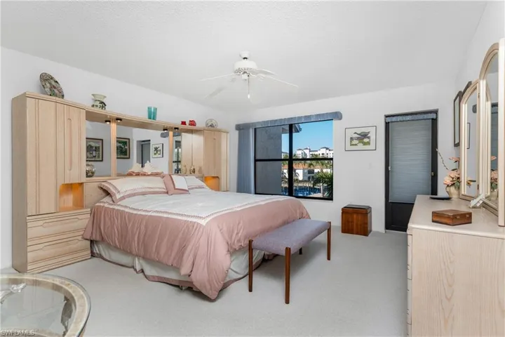 Bedroom with a ceiling fan and light carpet