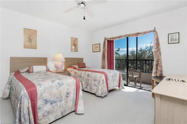 Bedroom featuring access to exterior, carpet floors, and a ceiling fan