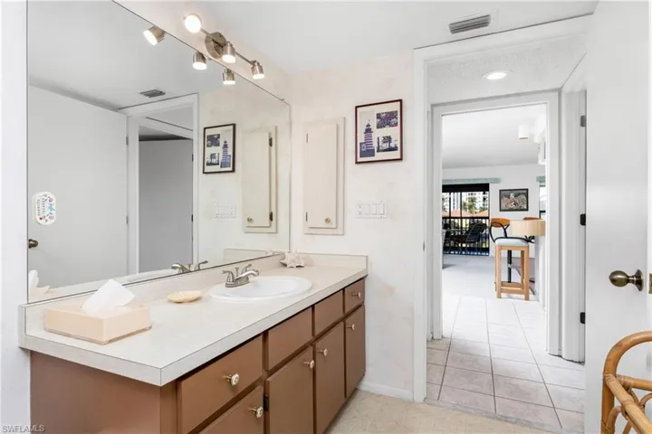 Bathroom with vanity, light tile patterned floors, and recessed lighting