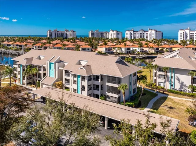 Drone / aerial view of apartment complex and a nearby body of water