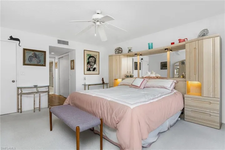 Bedroom featuring a closet, ceiling fan, and carpet flooring