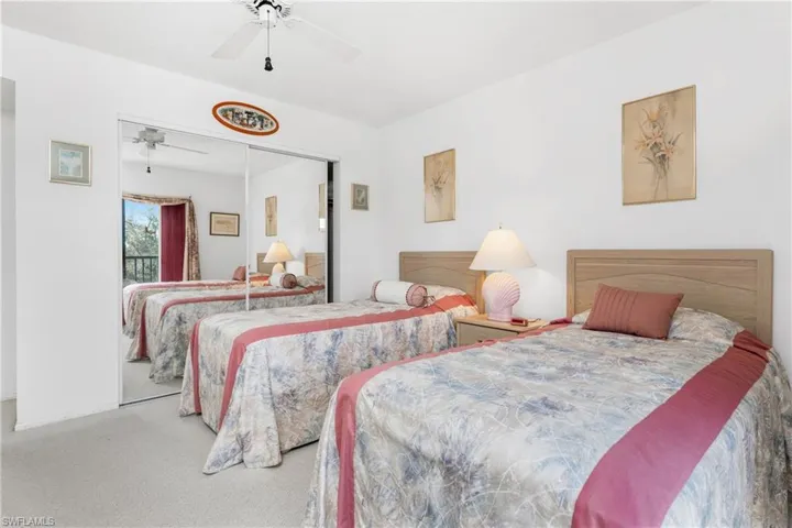 Bedroom with a closet, carpet, and ceiling fan