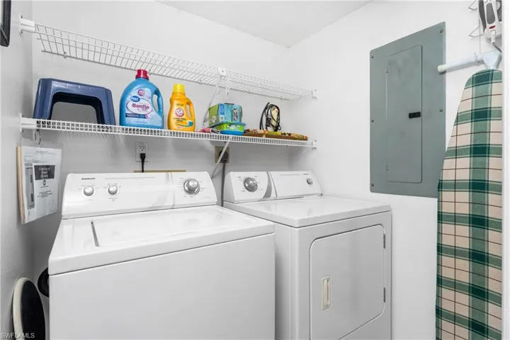 Laundry area with electric panel and washing machine and clothes dryer