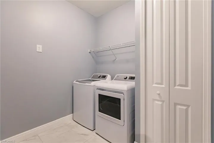 Laundry/utility room with washer and dryer included conveniently located for guest use off vestibule.