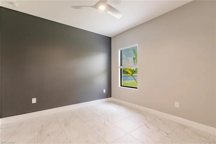 Bedroom 2 with adjacent full bath. Located to the right off vestibule.