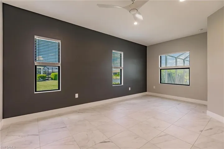 Primary en suite with windows overlooking pool/spa area and lake out back.