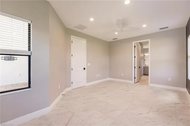 Big primary en suite with two walk-in closets between bedroom and bath.