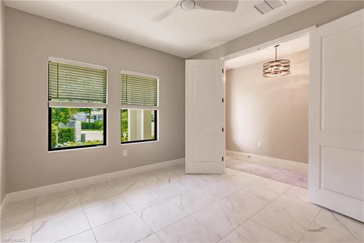 Bright den/leisure room off foyer.