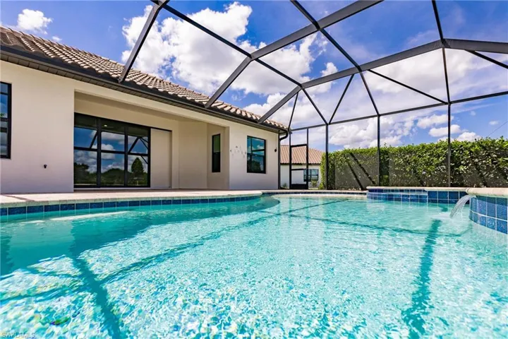 Crystal clear pool with integrated spa and waterfall feature. The sound of relaxation.