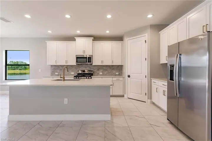 Kitchen with granite counter height island with deep sink.
