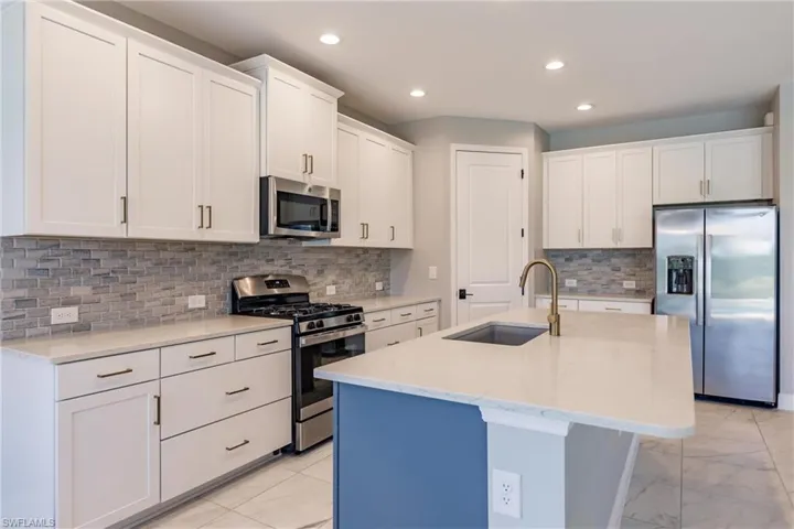 Chocolate cabinets under island. Natural lighting reflection made them look a little blue.