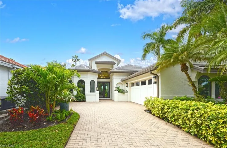 Lush tropical landscaping and fantastic curb appeal with new paint, new roof, new windows, doors and more