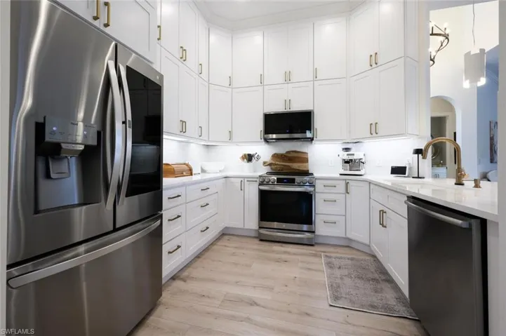 New custom kitchen cabinetry to ceiling, gleaming quartz countertops, backsplash, and LG appliances