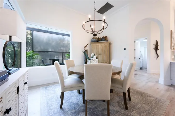 Formal dining area w/designer lighting and featuring courtyard views