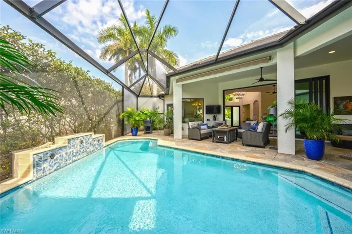 Sparkling pool waters featuring new pool cage and privacy Florida screens in the front