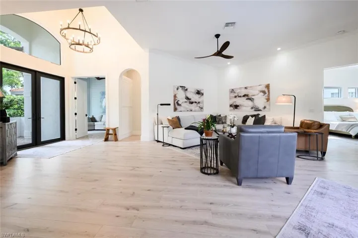 Natural light flows through the impact glass front doors and transom window