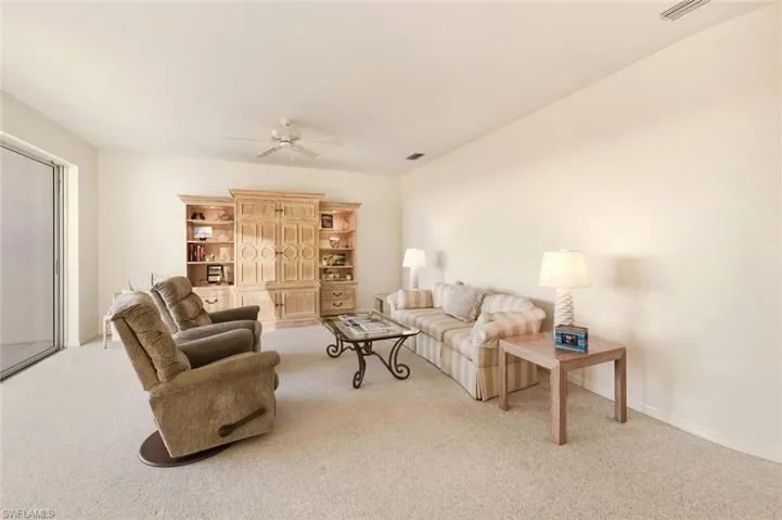 Living room featuring light carpet and ceiling fan
