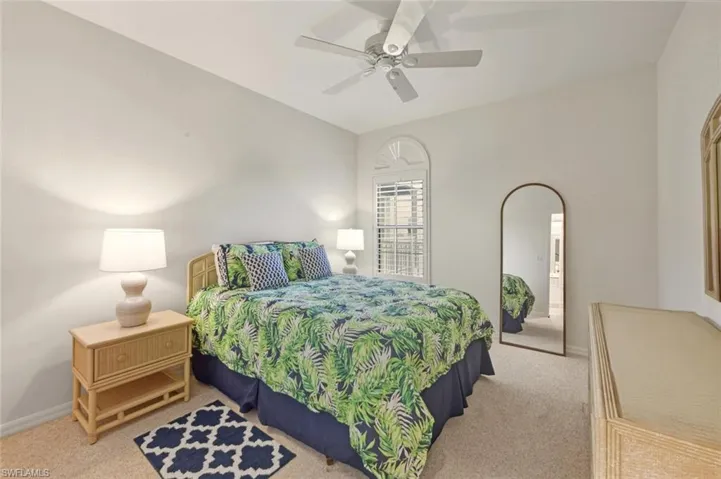 Bedroom with light colored carpet and ceiling fan