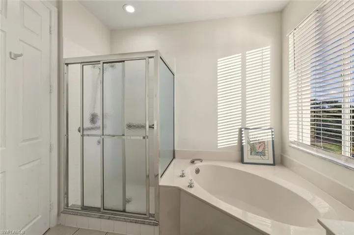 Bathroom with a garden tub and a stall shower