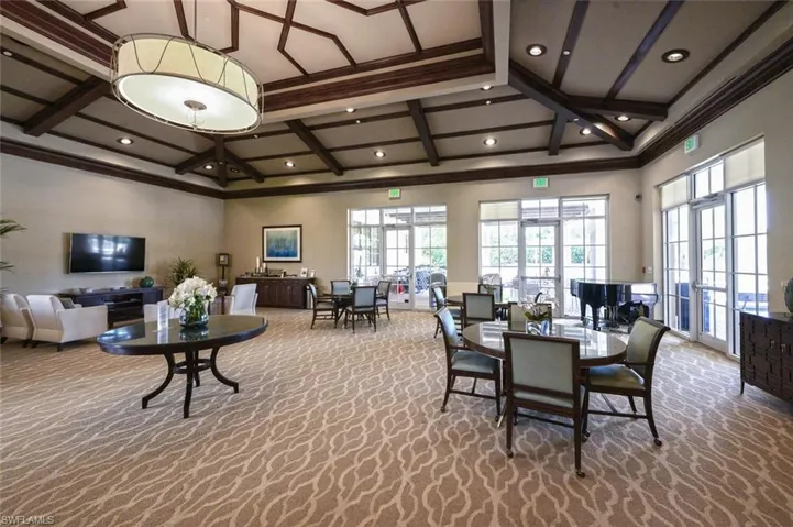 Dining area featuring coffered ceiling, carpet, beam ceiling, and ornamental molding
