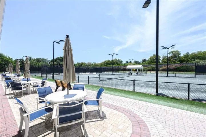 View of patio / terrace featuring a tennis court and outdoor dining space