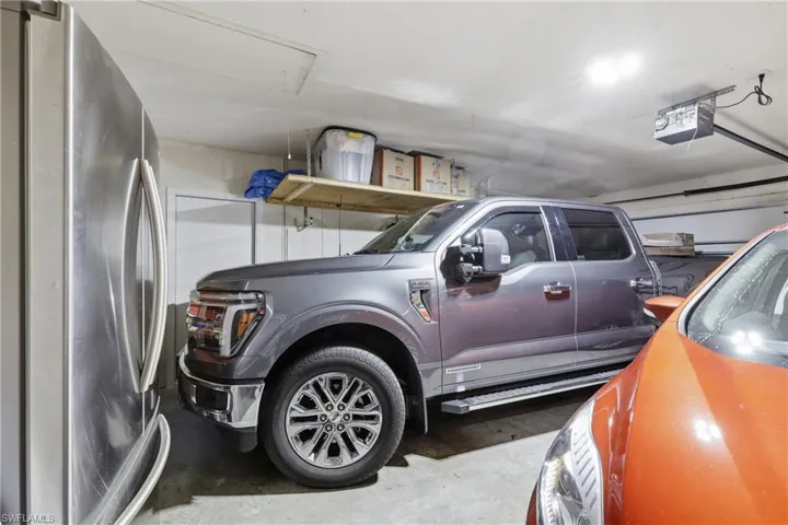 Garage with freestanding refrigerator and room for a truck!