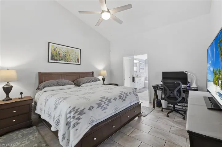 Primary Bedroom is large enough for an office area, high vaulted ceiling, ceiling fan, and ensuite bath