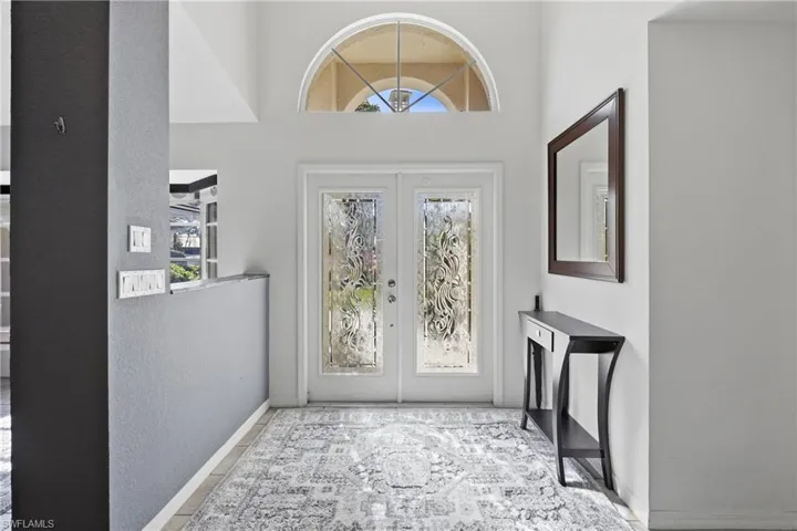 Foyer with decorative glass french doors.