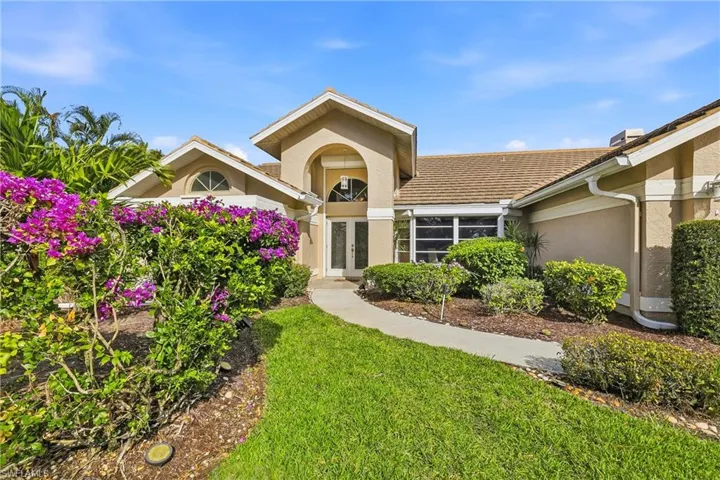 Front of Home with a large front lawn and stucco siding