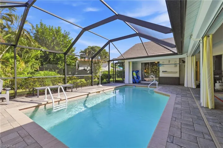 Pool in a private backyard and screen enclosure