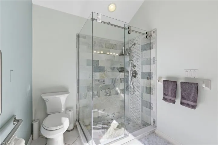Very lovely tile shower in gorgeous bathroom.