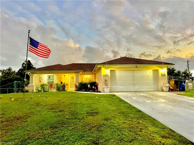 Single story home with stucco siding, driveway, and a garage