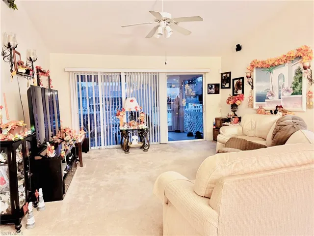 Living room featuring carpet floors and ceiling fan