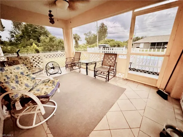 Sunroom / solarium with tile patterned flooring