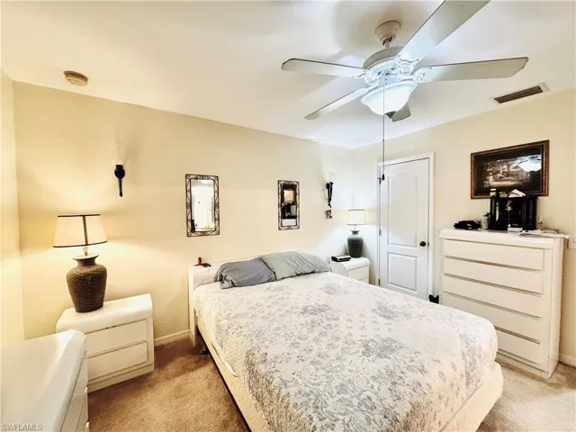 Bedroom with light carpet and ceiling fan